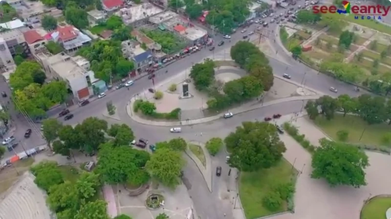 Aerial view of the western section of Champs de Mars, showing the roundabout, tree-lined plazas, and surrounding streets near the Sainte-Anne side of the park.