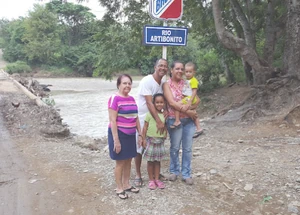 Local family poses in front of the river