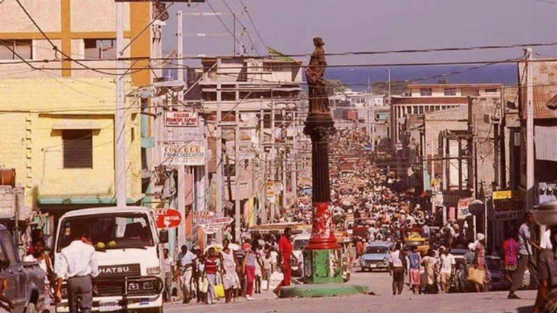 The Madame Colo fountain at Bel-Air’s edge, looking down a vibrant downtown Port-au-Prince corridor in the 1980s.