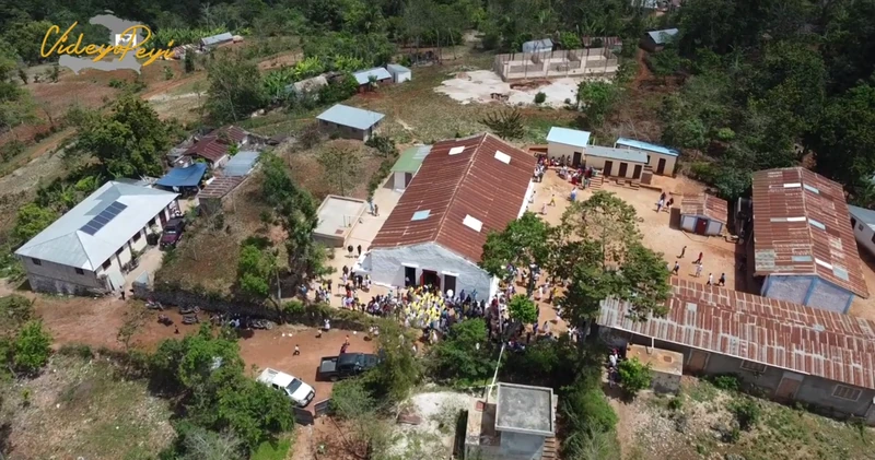 Aerial view of the Saint-Joseph parish in Goyavier, showing the church, school buildings, and surrounding lakou spaces.