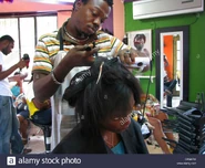 Young woman and hair dresser in a barber shop, Delmas, OU, Haiti