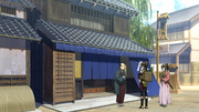 Chizuru and Heisuke talking to a merchant