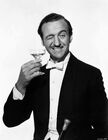 David Niven holding a martini glass and winking reference