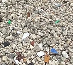 Mosaic pieces in the facade’s gravel