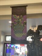 Beetlejuice Grave Halloween Horror Nights 30 Banner featured in the Bourne store [Image from HorrorUnearthed]