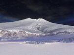 Snowbound at the foot of the mountain when viewed from a distance.