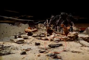 A Spartan Laser lies among the debris.