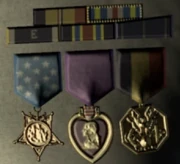 's military decorations include a Purple Heart (middle).