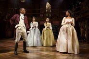 Burr conversing with Angelica Schuyler and the Schuyler sisters in "The Schuyler Sisters"