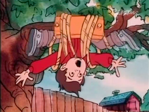 Spanky is tangled in a swing on a tree limb.