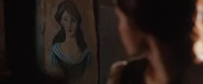 Looking at a picture of herself in Ben's room.