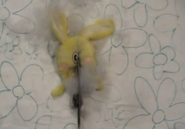 A deformed Cuddles doll from Splitting Hares video.