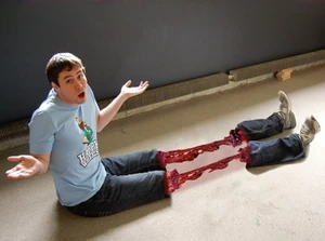 A fan-made blood gester on the knees with the person wearing a T-Shirt.