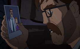 Jim with old photo of him and Barbara