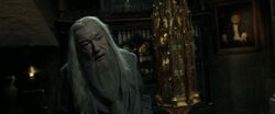 Dumbledore's standing by the Memory Cabinet