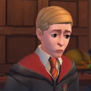 Zmartwiony Ben Copper w wielkiej sali w szatach Gryffindoru