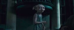 Dobby holding wand at Malfoy Manor DHF1