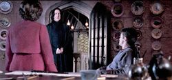 Umbridge talking to Snape while interrogating Harry Potter