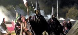 Death Eaters in their traditional garb terrorising Muggles
