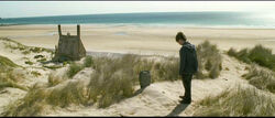 DH2 Harry Potter standing beside Dobby's grave near the Shell Cottage