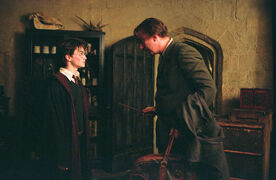 WB-F3-remus-lupin-and-harry-in-office-with-suitcase-web-landscape