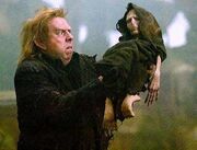 Peter Pettigrew holding Voldemort's rudimentary body