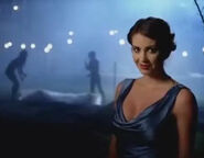 Lilith in a blue dress at the scene of a murder crime