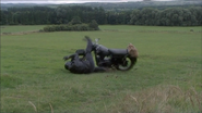 Ben's motorcycle hits the barbed wires and spins into the field