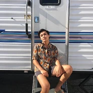 Leigh by their trailer on set.