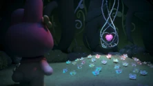  finds the pink heart from her dream under the tree.