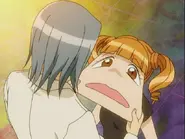 Keiichi stretching Uta's face.