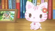 Nene, as an ordinary plush kitty, next to the picture.