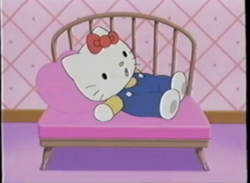 Kitty relaxing in a comfortable chair.png
