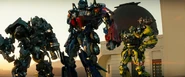 Ratchet stands alongside Optimus Prime and Ironhide