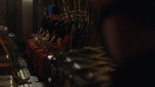 Hooded fugitive, a goggleless and headphoneless but hooded Hiro, Tracy, male fugitive (or Flint), female fugitive 2 and Sparrow are watched by a guard