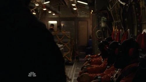 The fugitives being seated (down to up are Matt, female fugitive, hooded fugitive, Mohinder, Peter and hooded fugitive)