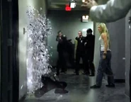 Tracy freezes a man and shoves him into a wall, shattering him.