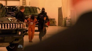 A hooded Claire is being taken to her father, Nathan