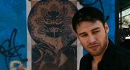 In front of El Vengador poster