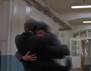 Peter grabs Sylar and flies him down the hallway.