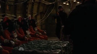 Two hooded fugitives and a hooded Sparrow are seated inside the plane.