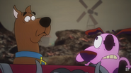 Courage and Scooby-Doo emerging from behind the Chest of Demons shocked.