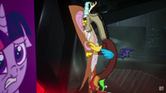 Discord patting Fluttershy's banner.