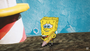 SpongeBob smiling at the grave he made for Super Friends Aquaman.
