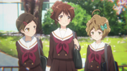 Hazuki, Kumiko, and Sapphire discussing the band on their way home