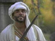 Haresh in the past confronting MacLeod