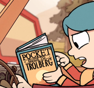Hilda reads some facts from Pocket Guide to Trolberg