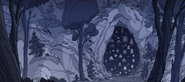 When fleeing, she stumbles upon a cave with tons of bells in front of the entrance.