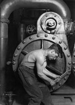 431px-Lewis Hine Power house mechanic working on steam pump