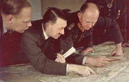 Hitler points at a map and Jodl looks.